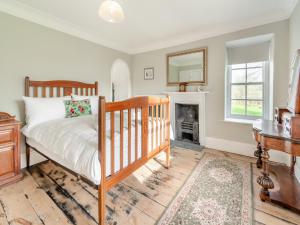 a bedroom with a bed and a fireplace at Maclaren House in Milford Haven