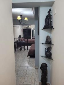 a hallway with shelves with vases and a dining room at Departamento Calle Corrientes in San Miguel de Tucumán