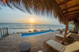 a view of the ocean from a resort with a swimming pool at Hotel Boutique Beso de Sal in Colán