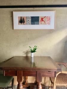a wooden table with a potted plant on top of it at Azukiya in Kyoto