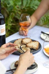 a table with a plate of food and a glass of wine at BIRD HOTEL in Kamakura