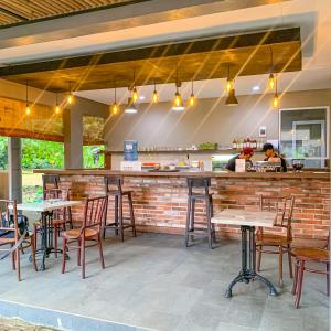 a restaurant with tables and chairs and a bar at INAGRO in Bogor