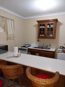 a kitchen with a counter top and a stove top oven at Cozy Villa Escape in Runaway Bay