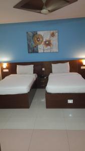 En eller flere senge i et værelse på Parco Residency