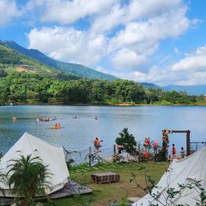 a group of people swimming in a lake at Đào Hoa Glamping in Hanoi