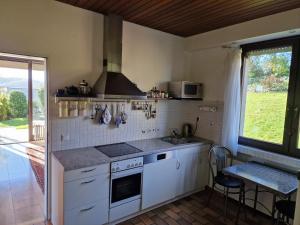 a kitchen with a sink and a stove top oven at Panoramahaus Sauerland in Arnsberg +29 photos