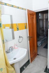 a bathroom with a sink and a mirror at Sandy's Homestay in Jammu