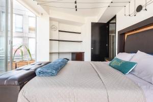 En eller flere senge i et værelse på Sky Coyoacan Depto con terraza privada