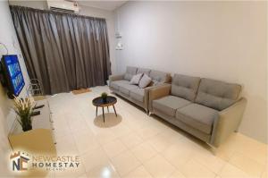 a living room with a couch and a tv at Newcastle Cozy Seri Impian Neflix Water Dispenser in Kluang