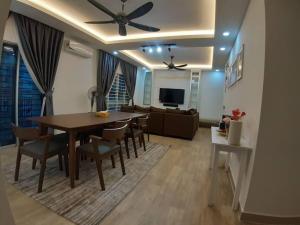 a dining room and living room with a table and chairs at 3R@7pax++ Spacious Space Putrajaya. in Putrajaya