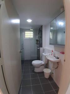 a bathroom with a toilet and a sink and a shower at 3R@7pax++ Spacious Space Putrajaya. in Putrajaya