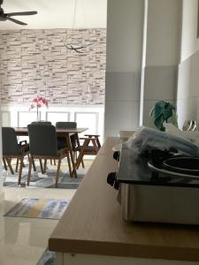 a kitchen and dining room with a table and chairs at Golden Oceanview at Icon Residence in Kuala Terengganu