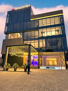 a person standing in front of a building at Signature Hotels in Visakhapatnam