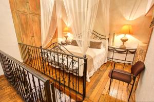 ein Schlafzimmer mit einem Bett und einem Balkon mit zwei Lampen in der Unterkunft La Mexicana Hotel Boutique in San Miguel de Allende