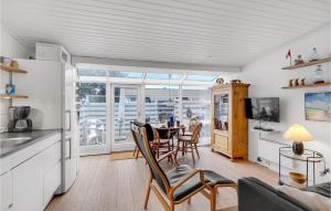 a kitchen and dining room with a table and chairs at Stunning Home In Vejers Strand With 1 Bedrooms And Wifi in Vejers Strand