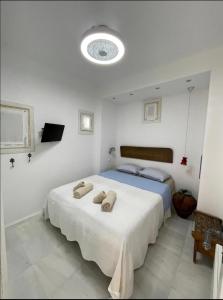 a bedroom with a bed with two towels on it at Private Town Apartments by Mykonos Eight in Mýkonos City