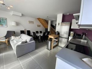 a kitchen and living room with a couch and a table at Maison Capbreton, 3 pièces, 6 personnes - FR-1-413-115 in Capbreton