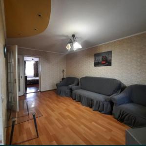 a living room with couches and a wooden floor at Two-bedroom apartment on Lenina avenue in Mykolaiv