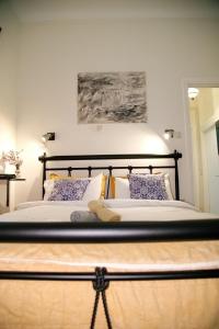 a bedroom with a large bed with two pillows at Aroura Homes Garden House 2BR 2BA Free Parking in Athens