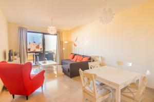 een woonkamer met een tafel en een bank bij 2114-Apt with nice terrace with pool view in Manilva