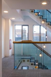 a staircase in a building with a glass floor at Church View, Geneva House in Peterborough