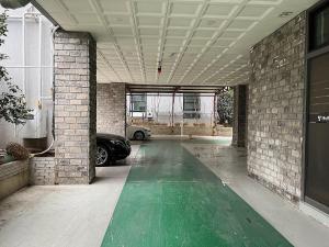 a garage with a green floor in a building at Guest 145 in Gwangju