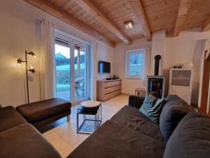 a living room with a couch and a fireplace at Lovely holiday home within walking distance of the ski slope and a subtropical swimming pool in Kötschach