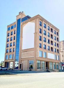 a building with a large arch on the front of it at Royal Vista Hotel in ‘Ibrī