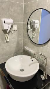 a bathroom with a white sink and a mirror at Only You Boutique Hotel Centrum Cameron Highlands in Brinchang