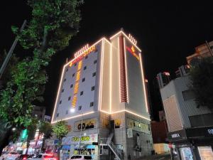 a building with a lit up sign on top of it at Cheonan Star Hotel in Cheonan