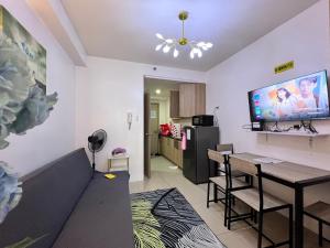 a living room with a couch and a table and a kitchen at Studio Units at Shore Residences Condo MOA Complex near Airport in Manila