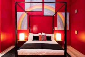 a bedroom with a double bed with a red wall at Central Rome Pop Art: space and luxury in Rome
