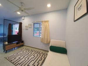 a living room with a couch and a tv at Go Homestay @ Kuala Kubu Bharu 