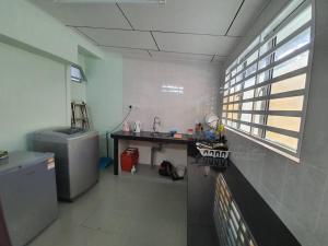 a kitchen with a sink and a desk in a room at Go Homestay @ Kuala Kubu Bharu 