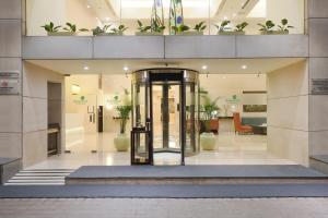 a lobby with a revolving door in a building at Lemon Tree Premier, Ulsoor Lake, Bengaluru in Bangalore