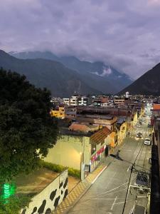 a view of a city with mountains in the background at Tiny apartment in the city rooftop terrace in Baños +5 photos