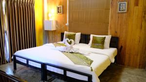 un dormitorio con una cama con una decoración de cisne en BAAN9NAN Home Lodge en Nan