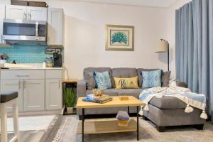 a living room with a couch and a table at Beach View & SeaBreezes in Corpus Christi