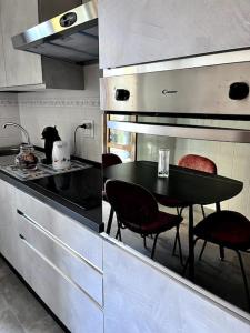 a kitchen with a table and chairs in a kitchen at La Ca Dei Nonni in Monterosso al Mare