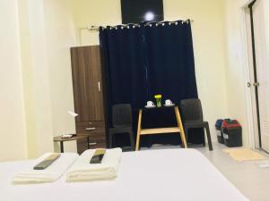 a room with two beds and a blue curtain at Avelina Inn in Siquijor