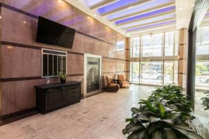 a living room with a television and a large lobby at Luxury 2BR/1BR in California Building in New Orleans