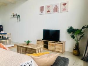 a living room with a flat screen tv on a stand at Minimalist Boho Loft,2-6pax, The Curve, IKEA, Bandar Utama, Damansara in Petaling Jaya