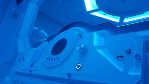 a toilet in a room with a blue light at Apollo Capsule Hotel in Ende