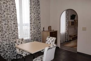 a dining room with a table and chairs at Отель Меридиан in Zolotonosha