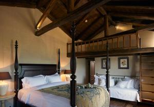 a bedroom with two beds and a loft at Villa Vager in Levidhion
