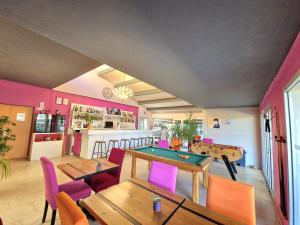 a room with ping pong tables and a bar at Hôtel Restaurant Le Mas De L'Olivier in Pont-Saint-Esprit