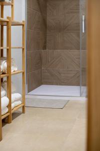 a shower with a glass door in a bathroom at Felipe Antón Suites in Mutxamel