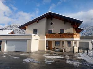 a large white house with a balcony on top of it at Appartement Fritzenwallner in Wagrain