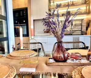 un tavolo con un vaso con dei fiori di Boutique lux design apartment @Bansko Royal Towers a Bansko