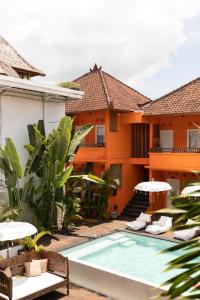 a swimming pool in front of a house at The Room Padang-Padang in Uluwatu